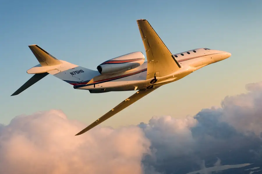 Citation X aircraft in flight above clouds